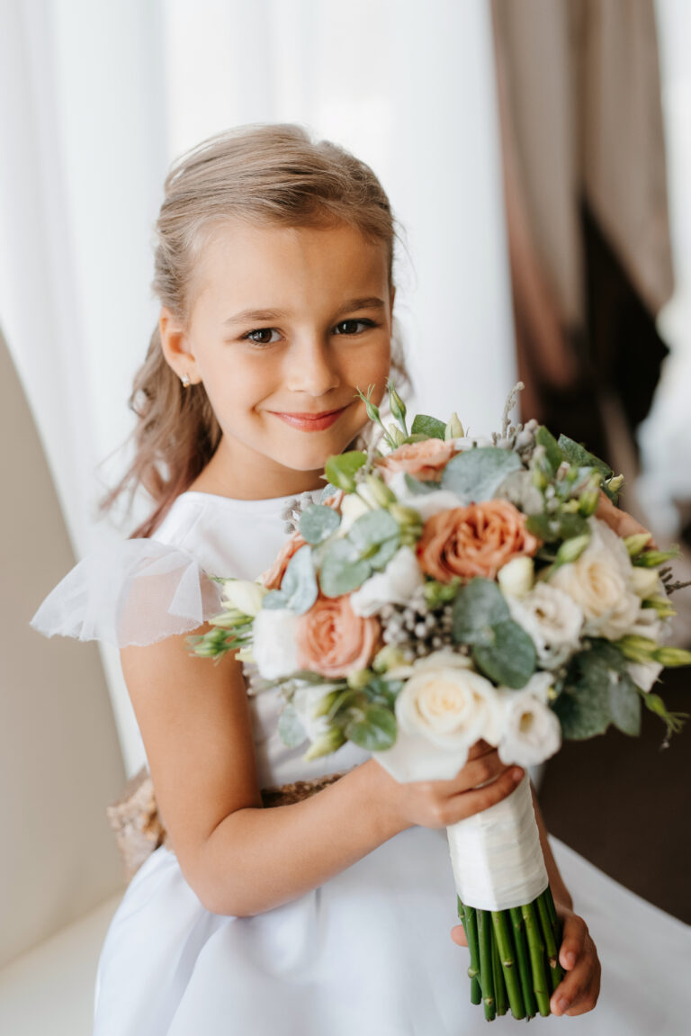 portrait of a flower girl in the morning before the wedding